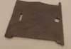A flat, gray, irregularly shaped object with two cutouts, likely a spare part for a stove or oven. Anteprima dell’immagine prodotto