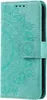 A teal flip case for a Samsung Galaxy S23 with a mandala pattern embossed on the cover. Produktbild-Vorschau