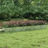 A raised garden bed filled with flowering plants sits on a grassy lawn, with trees in the background. Podgląd zdjęcia produktu