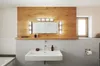 A modern bathroom sink area with a wooden accent wall, a mirror with integrated lighting, and a window. Podgląd zdjęcia produktu
