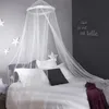 A bedroom scene with a bed draped with a canopy and decorated with star motifs. Náhľad obrázku produktu