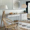 A bright and airy living room setting with a floor lamp, chair, console table, and chest of drawers. Podgląd zdjęcia produktu