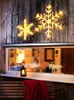 Two illuminated snowflake decorations are mounted on a wooden wall above a window. Produktbild-Vorschau