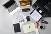 A desk with a laptop, printer, calculator, planner, and coffee cup. Náhľad obrázku produktu