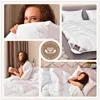 A collage of images showcasing a white duvet with a subtle pattern, featuring people using it in different settings. Produktbild-Vorschau
