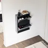 A gray shoe cabinet mounted on a white wall, with shoes inside. Produktbild-Vorschau