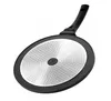 The underside of a black grill pan with a silver textured bottom and a black handle. Produktbild-Vorschau