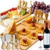 A cheese board set with various cheeses, grapes, waffles, and a bottle of wine. Náhľad obrázku produktu
