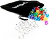 A black drawstring bag filled with colorful dice and a pile of clear glass beads on a white background. Podgląd zdjęcia produktu