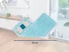 A turquoise mop head and its gray base are shown on a wooden floor, leaning against a white wall with a cabinet and window in the background. Produktbild-Vorschau