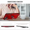 A person is holding a red smartphone case with a ring stand on a table. Produktbild-Vorschau