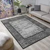 A living room scene with a rug, sofa, and artwork. Náhled obrázku produktu