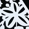 A close-up of a white decorative screen panel with a floral cut-out pattern against a black background. Náhled obrázku produktu