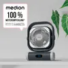 A Medion fan is displayed on a shelf with a plant in the background. A promotional badge is visible on the left. Produktbild-Vorschau