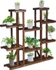 A wooden plant stand with multiple shelves holding various potted plants. Produktbild-Vorschau