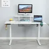 A white adjustable standing desk with a monitor, laptop, and accessories. Anteprima dell’immagine prodotto