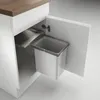 A pull-out trash bin system installed in a kitchen cabinet. Anteprima dell’immagine prodotto