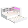 A white wooden bed frame with built-in shelving and LED lighting, along with an extended trundle bed, displayed against a white background. Produktbild-Vorschau
