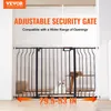 A black metal security gate is installed in a doorway, with a cat visible behind it. Náhľad obrázku produktu