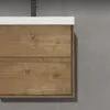 A close-up view of a wooden bathroom vanity with a white countertop. Produktbild-Vorschau