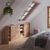 A bedroom attic space with a custom-fit cabinet under a slanted window. Produktbild-Vorschau