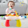 A baby is playing with a colorful musical activity table. Produktbild-Vorschau