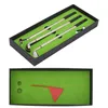 A golf pen set is displayed in a black box with green lining, and a separate box shows a miniature golf course scene. Voir les images du produit