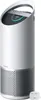 A white and silver air purifier with a digital display on top, shown against a white background. A small white power adapter is placed to the right of the air purifier. Náhľad obrázku produktu