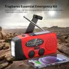 An emergency radio with a solar panel and hand crank is placed on rocks in an outdoor, mountainous environment. A smartphone is charging from the radio. Produktbild-Vorschau