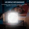 A person sleeping in bed next to a glowing thermostat on a nightstand. Podgląd zdjęcia produktu