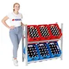 A woman standing next to a metal rack filled with crates of beer bottles. Produktbild-Vorschau