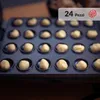 A close-up shot of a waffle maker with dough balls in each cavity. Anteprima dell’immagine prodotto