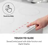 A close-up shot of a white induction cooktop with a hand touching the control panel. Podgląd zdjęcia produktu