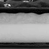 A close-up view of the layered construction of a dog bed, showing the fabric cover and the internal padding. Náhled obrázku produktu