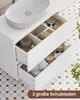 A white bathroom vanity with two open drawers filled with toiletries and towels, placed on a patterned tile floor. Voir les images du produit