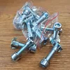 A collection of T-nuts and bolts on a wooden surface. Voir les images du produit