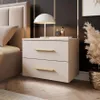 A bedroom scene featuring a bedside table with a lamp and decorative items. Produktbild-Vorschau