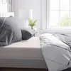 A close-up view of bedding on a bed, with pillows and a duvet cover. Produktbild-Vorschau