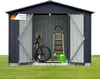 A dark gray metal shed with its doors open, displaying gardening tools, a bicycle, a ladder, and a watering can on a grassy lawn. Produktbild-Vorschau