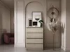 A dresser with artwork and a lamp on top, placed in a hallway with a chair and wall decor. Náhled obrázku produktu