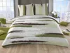 A bed with a duvet and pillows in a room with a large window showing a snowy landscape. Produktbild-Vorschau