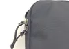 A close-up view of the zipper and pull tabs of a black bag. Náhľad obrázku produktu