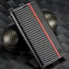 A close-up shot of a carbon fiber phone case with a red stripe, placed on a textured black surface with a carbon fiber sphere in the background. Produktbild-Vorschau