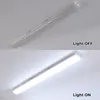 A split image showing a linear LED light fixture mounted on a ceiling, with the top half showing the light OFF and the bottom half showing the light ON. Produktbild-Vorschau