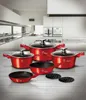 A set of red cookware is displayed on a kitchen counter in front of modern kitchen cabinets. Produktbild-Vorschau