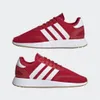 A pair of red Adidas sneakers shown from a side view against a plain white background. Produktbild-Vorschau