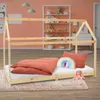 A child's bed with bedding and pillows in a bedroom setting.
