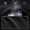 A close-up of black fabric with icons and steam indicating features. Produktbild-Vorschau