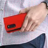 A person holding a red flip-cover phone case. Produktbild-Vorschau