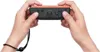 Two hands holding a Nintendo Joy-Con controller. Produktbild-Vorschau